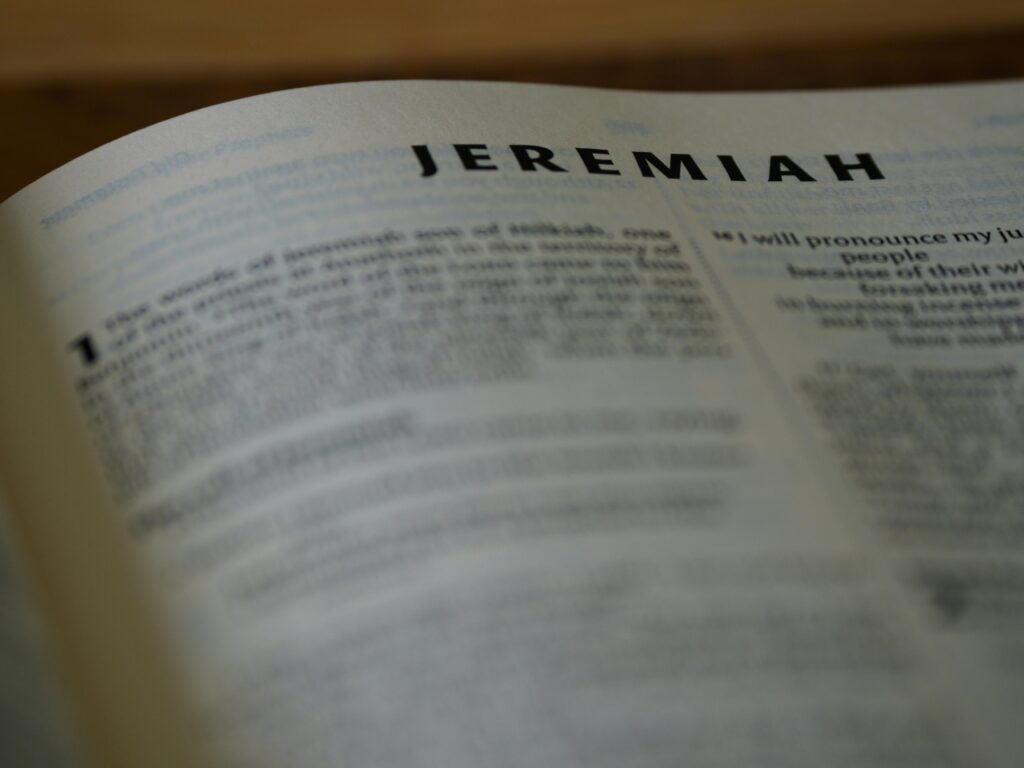 HOW DO I HEAR GOD’S VOICE? Detailed close-up of the Book of Jeremiah in the Holy Bible with text in focus.